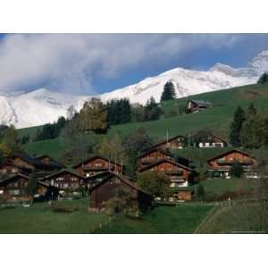  Wooden Chalets on Slope with Snow Capped Peaks in the 